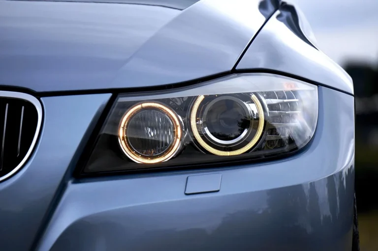 LED and halogen headlights illuminating a dark road with different beam reach