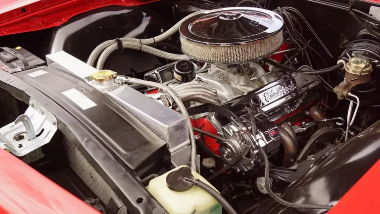 Mechanic inspects a dirty car engine air filter inside the open engine bay