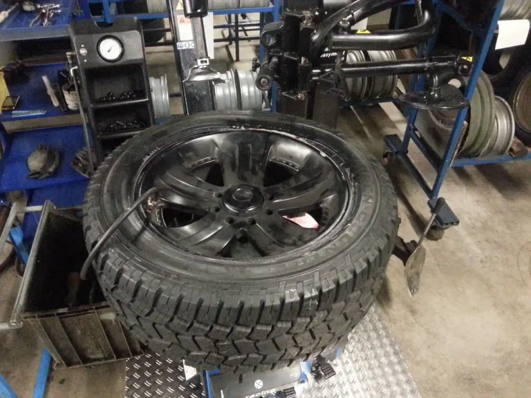 Winter tires on a sedan braking on an icy road at dawn with snowbanks nearby