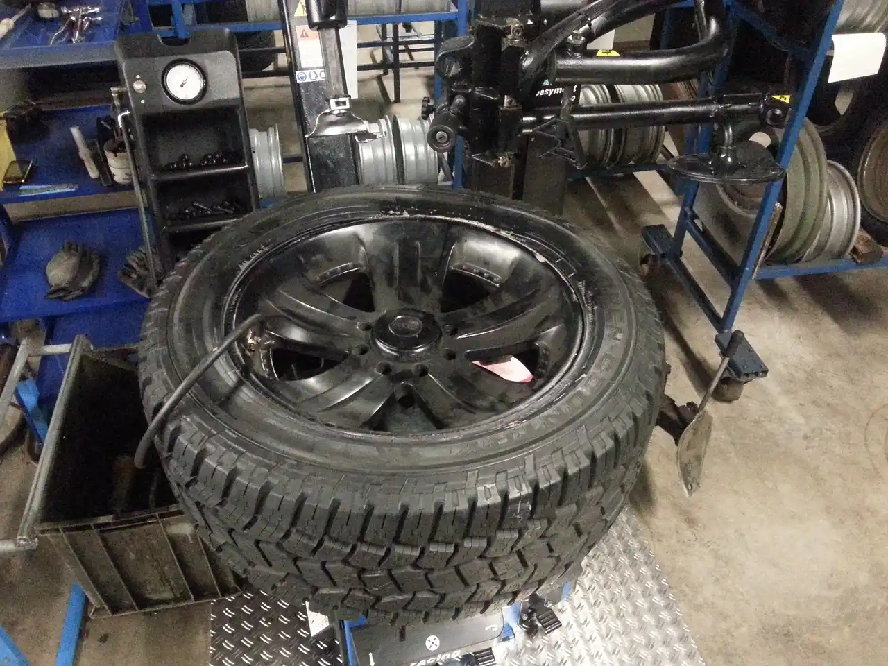 Winter tires on a sedan braking on an icy road at dawn with snowbanks nearby